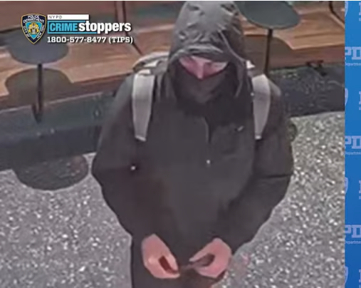 CCTV-style still showing a hooded person in dark clothing with backpack straps visible, photographed from above. NYPD Crime Stoppers branding and the phone number 1-800-577-8477 (TIPS) appear in the upper-left corner.