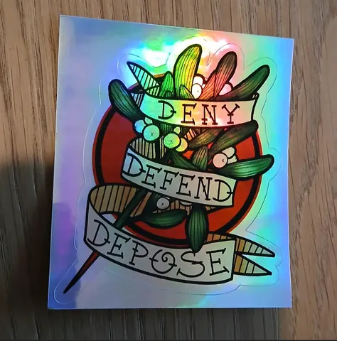 Holographic sticker or print with tattoo-style ribbons reading 'DENY DEFEND DEPOSE' over an illustrated arrangement of plant and tool-like shapes.