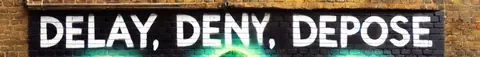 A narrow image showing the phrase 'DELAY, DENY, DEPOSE' in large white letters across a dark background.